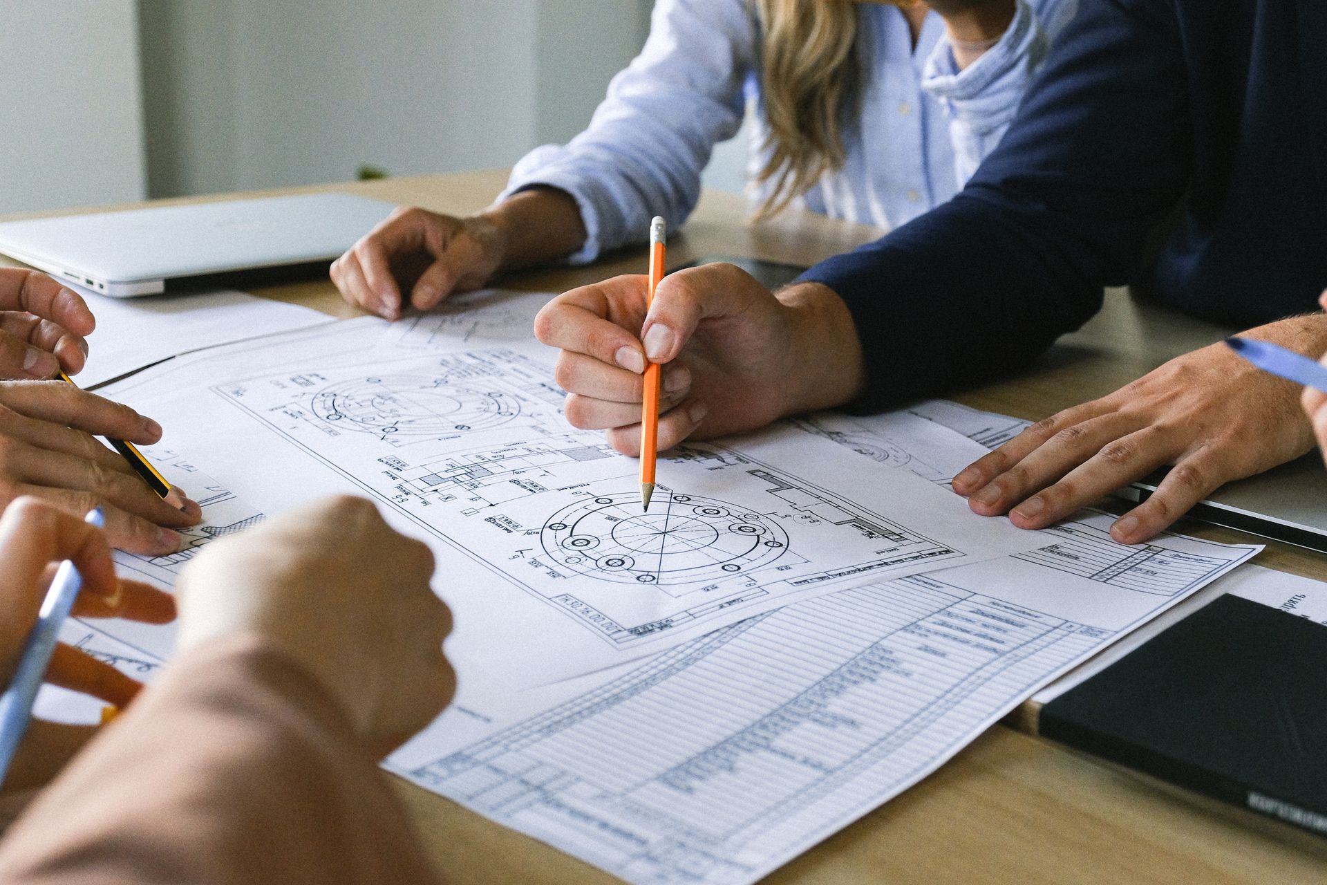 Engineers reviewing technical drawings and mechanical schematics